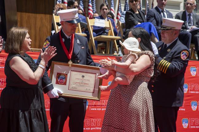 Lieutenant James M. Corey pictured with his family while being awarded for his courageous water rescue on March 31, 2025.
