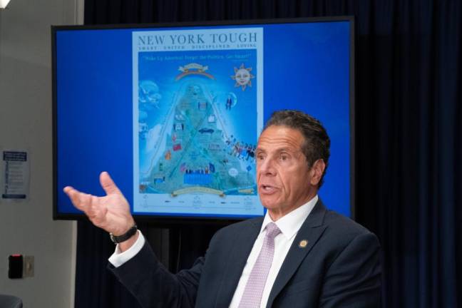 Governor Andrew M. Cuomo with his poster depicting the pandemic in New York. Photo: Don Pollard / Office of Andrew M. Cuomo