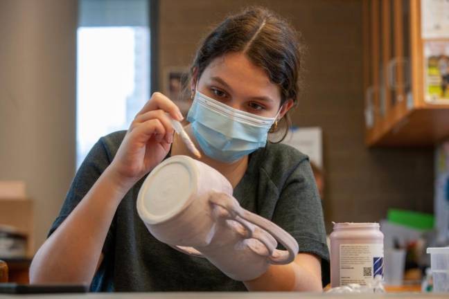 An Upper School Studio Arts student puts the finishing touches on her ceramic design at Trevor Day School. Photo: Greg Morris Insight Visual