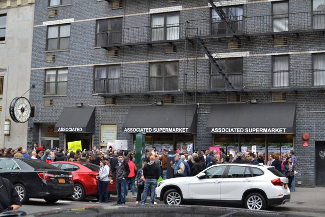 The closing of a supermarket is typically a time of great trauma, as this scene in Chelsea in the spring of 2016 highlights. Residents protested the closure of one of the only affordable suppliers of fresh produce in the neighborhood after the market's rent spiked dramatically. Photo: Madeleine Thompson