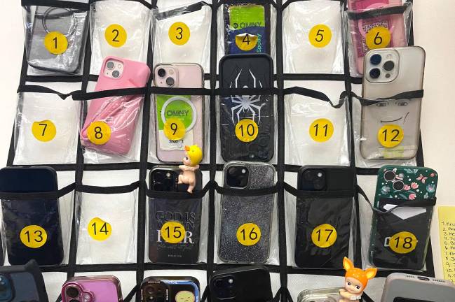 Students in a statistics class at New Heights Academy Charter School in Harlem store their phones in pouches at the back of the classroom on Tuesday, May 6, 2025. A statewide cellphone ban will take effect this fall.
