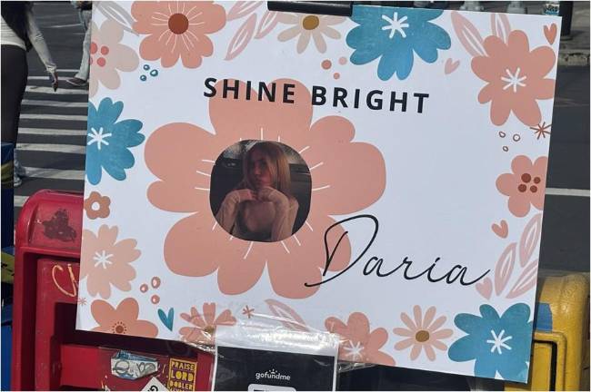 Community residents and friends erected a makeshift memorial at the corner of East 14th Street and First Ave. where Daria Serkov was killed while riding an e-bike that was struck by a truck making a right hand turn.