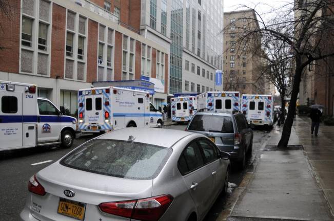 A typical congested street scene on East 77th Street with double- and triple-parked ambulances outside Lenox Hill Hospital's emergency room, one of the issues redevelopment was intended to address.
