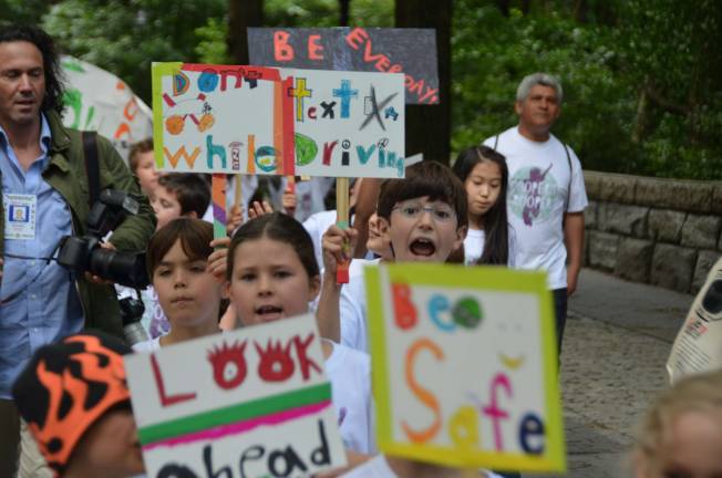 Calhoun School students march in memory of former classmate Cooper Stock, who was killed by a reckless cab driver last January. The students called themselves &quot;Cooper's Troopers&quot; and carried homemade signs highlighting safe driving. Photo by Daniel Fitzsimmons.