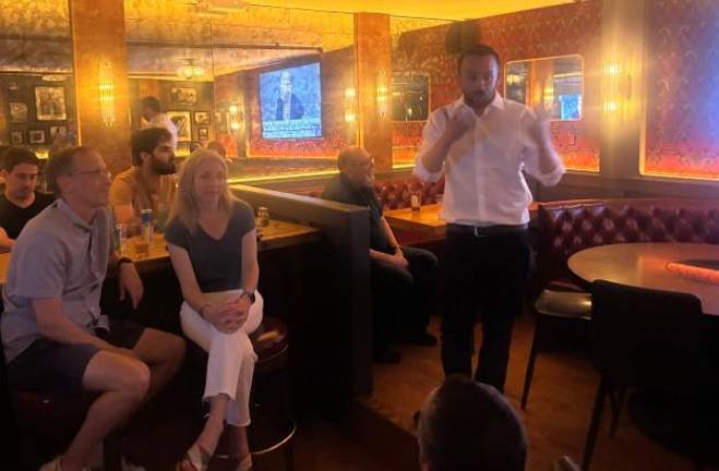 Keith Powers held his watch party at Shades of Green on East 15th Street. He thanked his girlfriend Layla Amjadi (seated, center) and longtime chief of staff Ben Jacobs (among others) for their support.