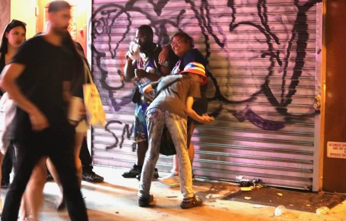 Fans sprayed graffiti on a metal storefront gate near Times Square during the Knicks victory celebration.