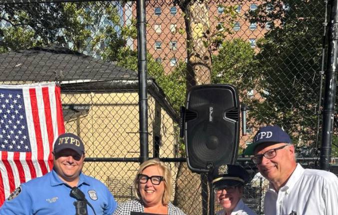 Assembly member Rebecca Seawright (second from left) is flanked by 19th Pct. community affairs officer Brian Larkin (left) as she presents a proclamation to deputy inspector Noreen Lazarus for her work as the commanding officer of the 19th Pct. Community Council president Nick Viest (far right) joins in.