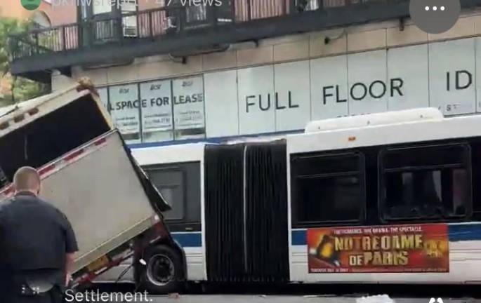 A box truck partially overturned and slammed into an MTA bus on E. 85th and Lexington Ave. on the morning of July 13. Photo: Citizen app