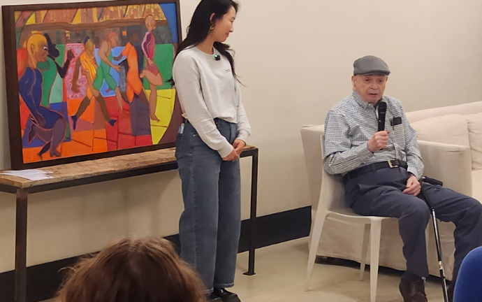 Ben Feldshuh fields a question at his first ever art show while Jenny Lee, the CEO of HERA looks on. She “discovered” the 88 year old retired psychiatrist had decades of worth of work he had painted over decades.