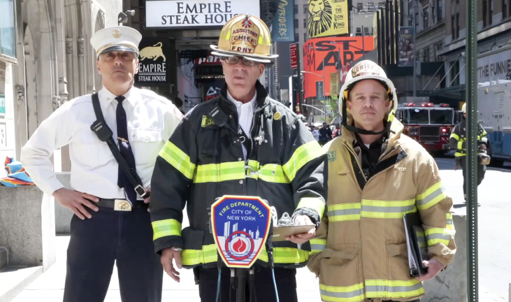 FDNY deputy chief David Simms (center) speaks at press conference at 230 West 49th Street after the three alarm fire was extinguished on May 4.