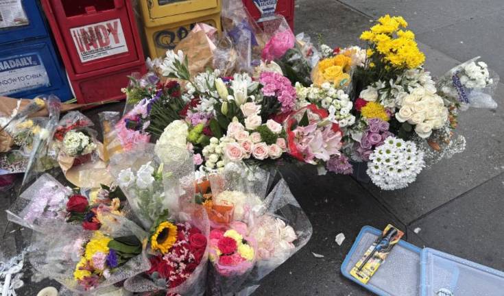 A steady rain did not stop a growing memorial in the East Village intersection on Sunday where a teenage girl was killed Sept. 18 when an e-bike she and a friend were riding together was struck by a truck making a right hand turn onto First Ave. from East 14th Street.