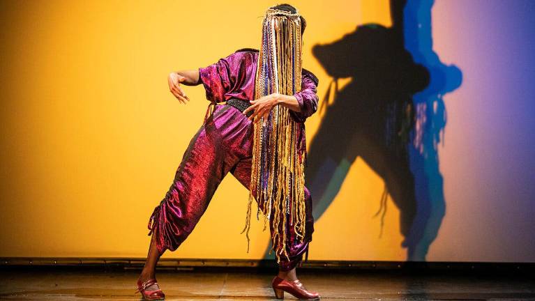 Yinka Esi Graves is pictured on stage and performs flamenco.