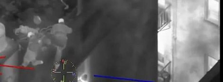 Firefighters had to repel down from the roof of the sixth story building to rescue people trapped on window ledges three times. Photo: courtesy NYPD