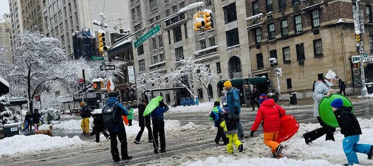 With a true snow day from school, the first in NYC since 2019, kids such as this crew heading down Lexington Ave. at 79th St. were spending the afternoon sledding in Central Park.