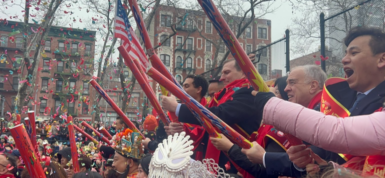 Dan Goldman, on the grandstand at the kickoff celebration of Lunar New Year in Sara D. Roosevelt Park in Chinatown, gets ready to pop a confetti stick on Feb. 17.