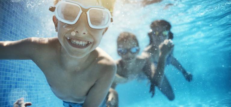 Kids coming down the slide in the brand-new Olympic-size Gottesman Pool at the Davis Center in Central Park. The pool opened for its first summer season on June 27. Gottesman Pool is one of only two public pools in Manhattan offering Learn to Swim programs this summer.