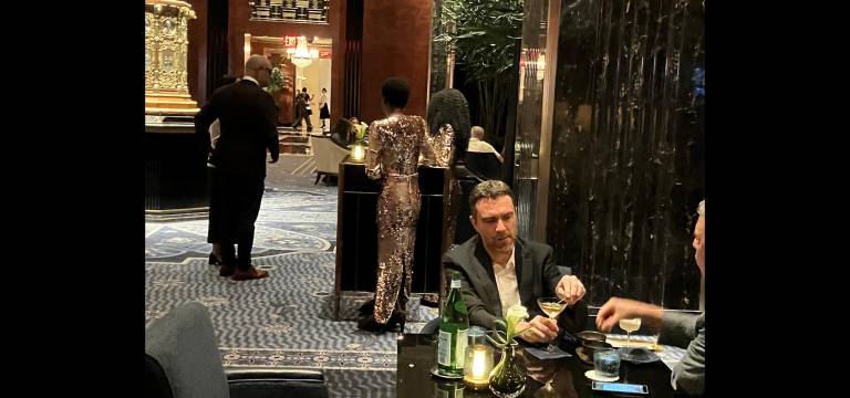 Martinis and mermaids in the Waldorf Astoria’s famed Peacock Alley. The hostesses wear stunning floor-length flashing gold gowns.