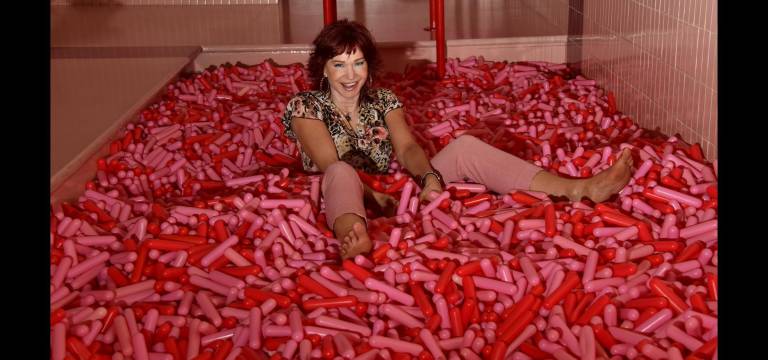 Karen Rempel frolics in the sprinkle pool at the Museum of Ice Cream.