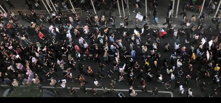 Thousands of immigration protestors marched past Film Forum on W. Houston Street on June 10, some draped in Mexican flags and carrying signs. “I’m here for those who can’t be here.”