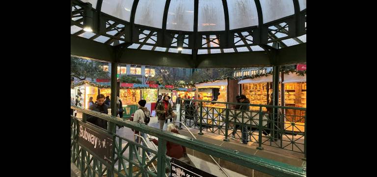 Holiday shoppers emerge from the rotunda of the Union Square subway station into a festive holiday scene.