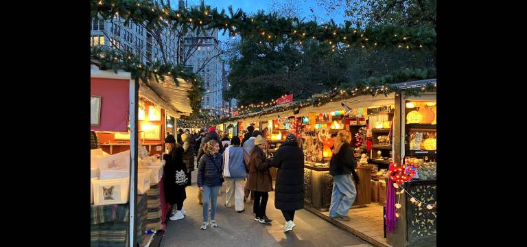 After-work crowds peruse the unique handcrafted gifts at the Union Square Holiday Market.