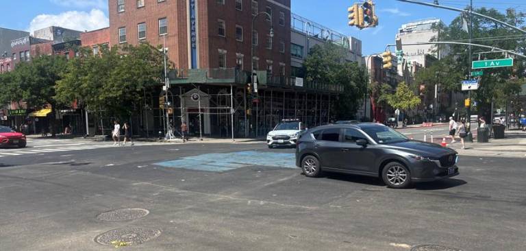 Steel plates were placed over the excavation that was made at the intersection of First Ave. and East 14th Street after a water main break burst on Aug. 3, flooding the street and snarling traffic. Patchwork repairs enabled the intersection to finally be reopened Aug. 9