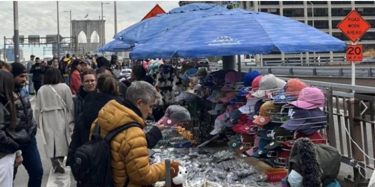 Vendors on the Brooklyn Bridge are crowding out pedestrians and the DOT wants to boot them. Mayor Adams agrees with the proposed regulations but recently city council member Gale Brewer said she plans to introduce a new bill that will permit some vendors to stay. Photo: Nicholas Liu