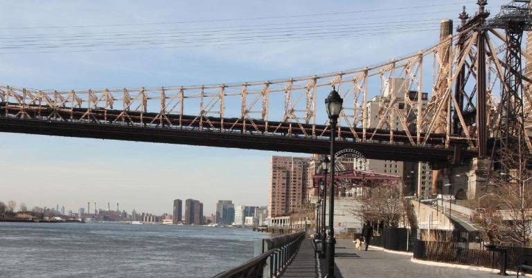 The Roosevelt Island Tramway looking south along the East River Esplanade.