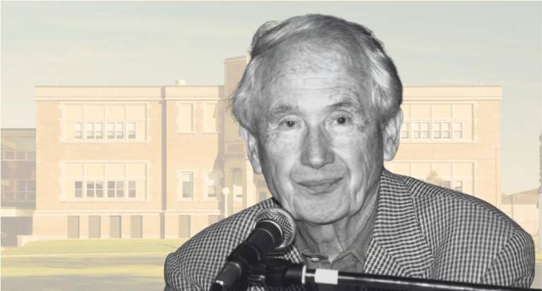 Frank McCourt, before a photo of the original Stuyvesant High School on East 15th Street, where he was a creative writing teacher for 20 years before becoming the Pulitzer Prize winning author of “Angela’s Ashes.”