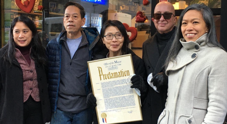 The city honored Rupert Jee (second from left) and his business partner May Chin (holding document) with a proclamation from Mayor Eric Adams on Jan. 31, 2022 “to celebrate the Hello Deli’s contribution to the fabric of the neighborhood.” Photo courtesy of Mayor’s Office of Media and Entertainment