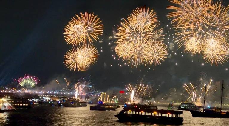 July 4th fireworks blasting, photographed from the East River.
