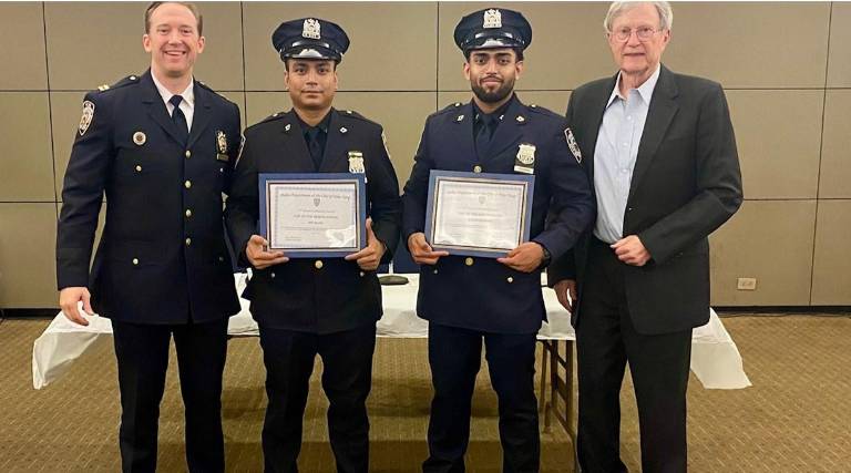 Captain Allen Kirmss, commanding officer of the 17th Pct. presented officer of the month to Officers Ramman and Islam, who apprehended a suspect who had robbed a street vendor at knifepoint. Don Reid from the 17th Pct. community council is right.