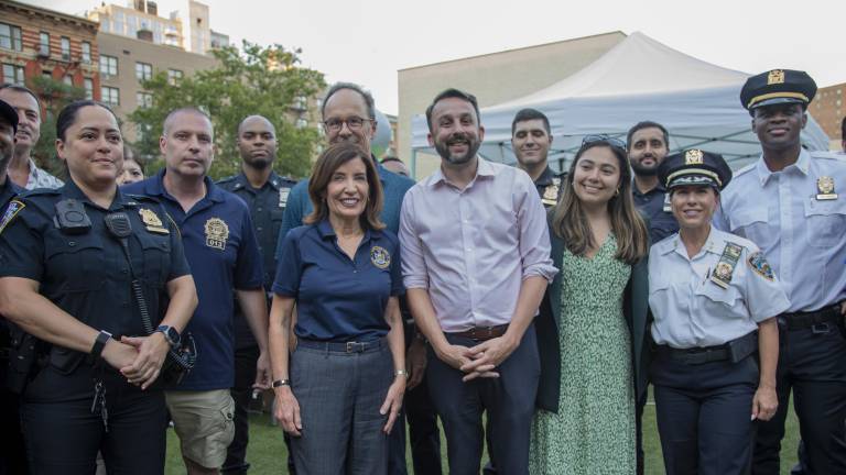 Gov. Kathy Hochul (center) meett with police officers at the 13th Pct. National Night Out Against Crime along with NYS Assembly Member Keith Powers (white shirt) and NYS Senator Kristen Gonzalez (green dress) on Aug. 4 at Peter’s Playground on Second Avenue and East 20th Street.