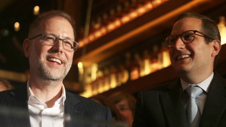 City Comptroller Mark Levine, left, and Micah Lasher, right, laugh as Manhattan Borough President Brad Holyman-Sigal delivers a congratulatory speech.