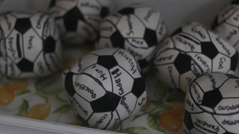In one section of Our House NYC set up for children, small soccer balls have been marked with different emotions as part of an emotion naming exercise.