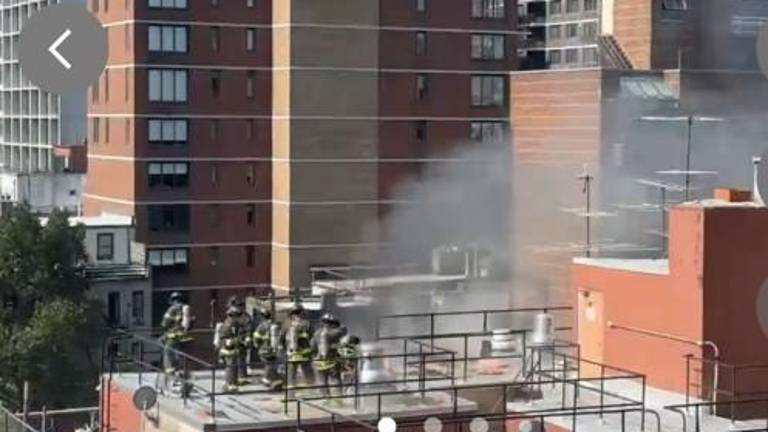 Firefighters were able to quickly extinguish the blaze that erutped at 305 E. 95th St. The fire started on the roof and spread to the cockloft and three penthouse apartments on the top floor of the seven-story building.