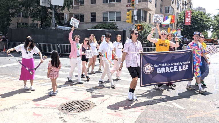 Assemblymember Grace Lee is on scooter duty with her eight year old daughter at NYC Pride March.