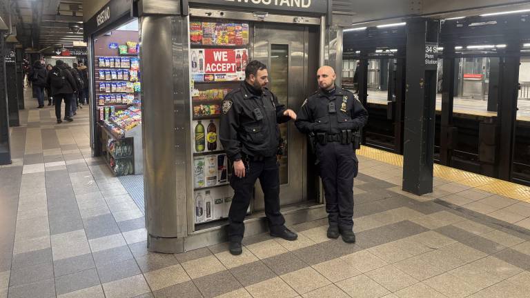 Governor Hochul is proposing to allocate $77 million to extend the police surge in NYC subways so that every train running from 9 p.m. to 5 a.m. has two cops on board. Cops above were at the Seventh Avenue — Penn Station stop.