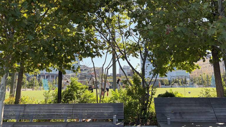 Benches where homeless people have been spotted sleeping are pictured outside of the athletic field on Aug. 25.