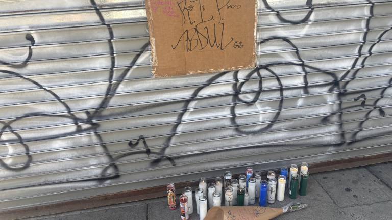 There were candles, flowers and a handwritten sign at a growing, makeshift memorial outside Sal’s Deli and Grocery were Abdul Saleh worked. He was killed after a scuffle with another man on the night of April 25.