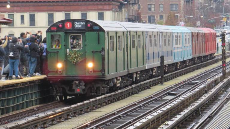 At the West 125th Street/Broadway Station, the Train of Many Colors, heading towards Chambers Street, stops to pick up passengers on November 27,2022. Photo by Ralph Spielman