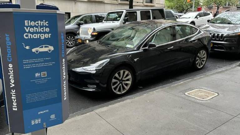 An electric Tesla parked in the charging spot without using the charger. Photo: Tom Goodman