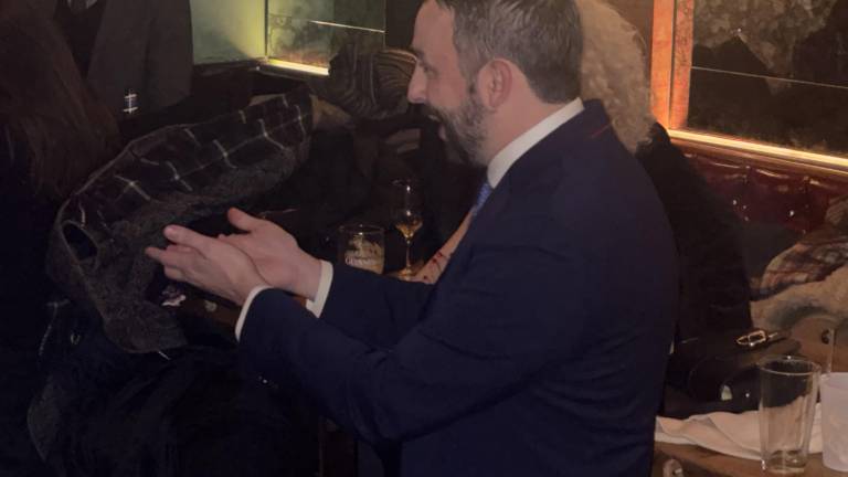 Keith Powers extends his hands in thanks to Harvey Epstein, who dropped out of the Assembly to run and win a seat in the City Council and endorsed Powers as his successor for the Assembly seat.