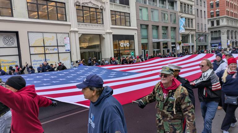9/11 Volunteers carrying the American flag at Veterans Day Parade.