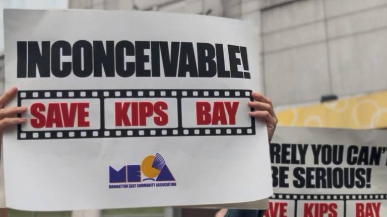 Protestors held signs and chanted “Save our theater!” outside of the Kips Bay AMC 15 in protest of its planned closure at the end of the year.