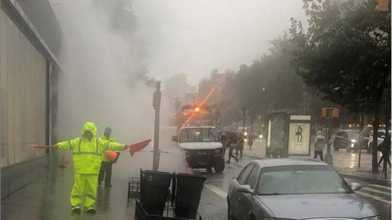Sidewalk closed as water turned to steam below ground and the resutling steam blast forced a manhole cover to rotate ominously at E. 16th St. and First Ave. Photo: Keith J. Kelly