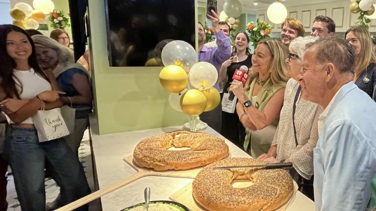 Ess-a-Bagel Celebrates 50th Anniversary with huge bagels that in were cut in lieu of a ribbon, with a pizza dish-sized platter of cream cheese adjacent. Only in New York!
