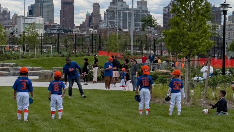 Our Lady of Sorrows’ Little League Mets warming up before a game.