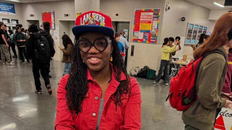 Art &amp; Design student Irene Mok hands out stickers at Art &amp; Design Day, Nov. 8, 2024.