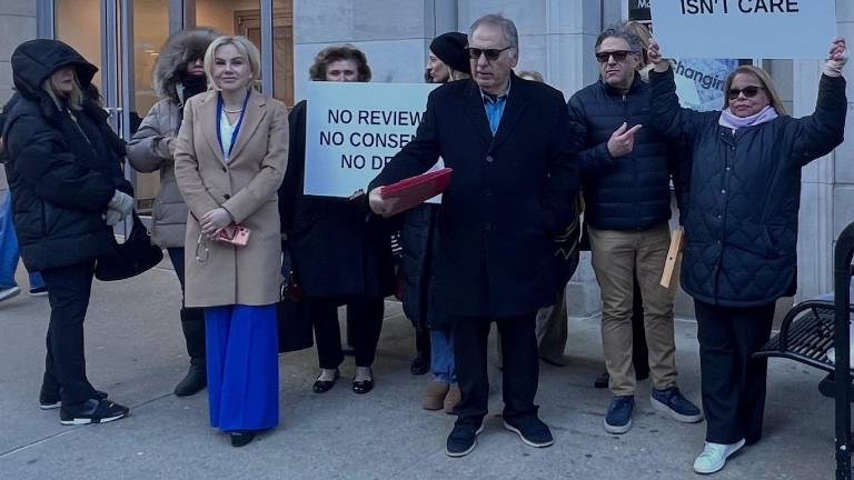 A group calling itself the East Side Accountability Alliance, plus GOP State Senate candidate Alina Bonsell (left, tan coat), rallied on March 18 against the planned opening of a homeless shelter on First Ave.